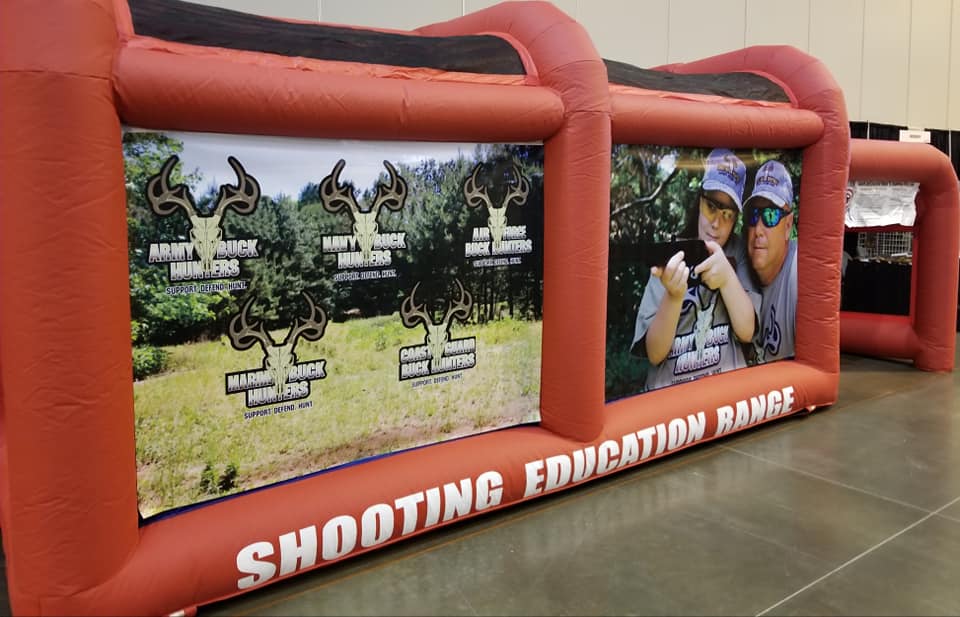 People posing in front of the ArmyBuckHunters BB Gun Range